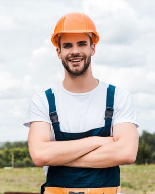 selective-focus-of-happy-repairman-standing-with-c-2022-11-02-01-58-52-KMXSH29